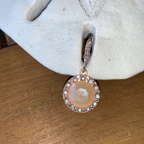 Peach colored earrings surrounded by crystals. - Picture 4 of 5